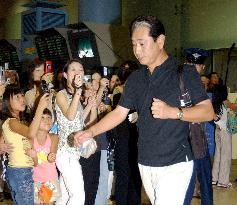 Hoshino tight-lipped on return from U.S.