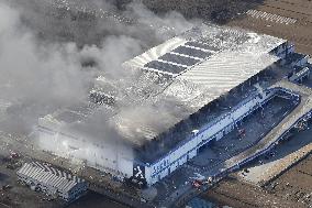 Fire continues to burn Japanese firm's distribution center