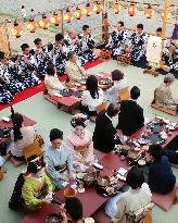 Visitors enjoy cuisine on riverside terrace in Kyoto
