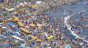 Crowded beach in sizzling Japan