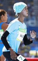 Olympic scenes: Somalian runner warms up for women's 400 meters
