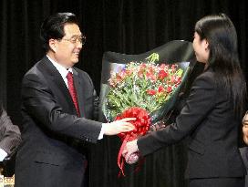 China's President Hu receives bouquet of flowers from Chinese stu