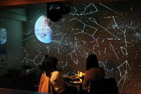 Stargazers look up to sky in middle of neon signs in Osaka