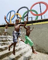 Children play in water in Brazilian summer heat