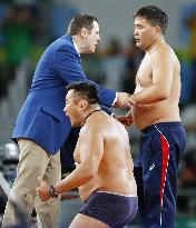 Olympics: Mongolian wrestling coaches strip in protest