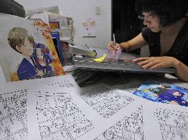 Manga comic artist works on digital board