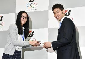 Olympic swimming gold medalist Hagino at firm's welcome ceremony