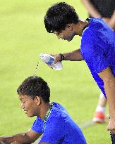 Olympic scenes: Soccer player cools down teammate
