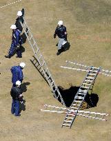 Investigators examine hole on golf course in Hokkaido