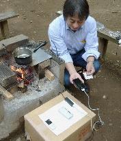 Charging cellphones with heat from open fire
