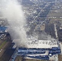 Fire continues to burn Japanese firm's distribution center