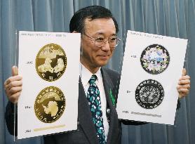 (Caption Corrected) Tanigaki unveils two 50th anniversary coins