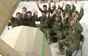 Japanese GSDF troops watch soccer friendly match