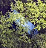 Minibus slides down mountain slope in Japan