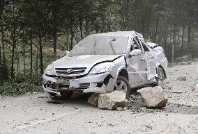China earthquake -- vehicle crushed by falling rocks