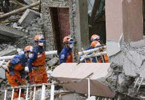 Japanese relief team continues to look for signs of life