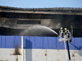 Fire continues to burn Japanese firm's distribution center