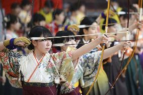 Women coming of age shoot arrows in celebration