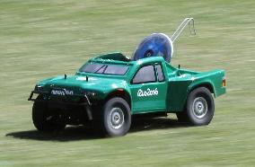 Olympic scenes: Radio-controlled vehicle returns discus