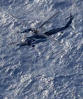 Search for crew members continues after ASDF chopper crash