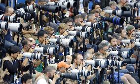 Olympic scenes: Ranks of telephoto lens cameras