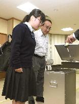 Politically savvy teen casts 1st early vote in Japan lower house election