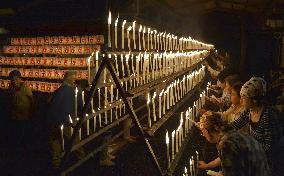 Well-wishers light candles at shrine in western Japan