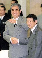 New Tokyo Gov. Ishihara shakes hands with former governor