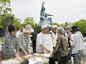 Nagasaki a-bomb survivors collecting signatures