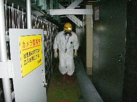 Workers measure radiation inside No. 1 reactor building