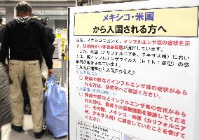 Japan calls on public for alert, composure over swine flu