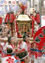 Women carry portable shrine in Tenjin Festival