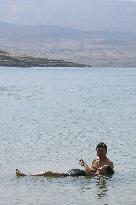 Woman floats on Dead Sea