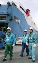 Inspectors check ships for insurance at Yokohama port
