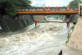 People washed away by rain-swollen river