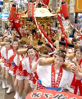 Women carry portable shrine in Tenjin Festival in Osaka