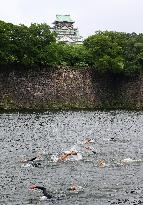 Triathletes swim in Osaka castle moat