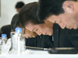 Japanese executives bow in apology