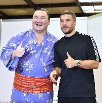 Yokozuna Hakuho and ex-Germany striker Podolski