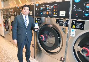 Smartphone-linked coin laundry service