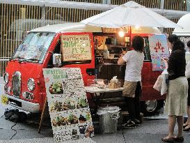 Lunch van village drawing businesspeople in Tokyo