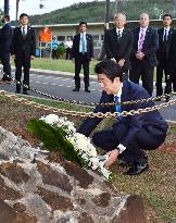 Abe tours military graves ahead of Pearl Harbor visit