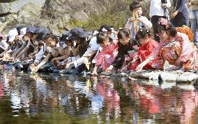 "Hina" dolls float on river