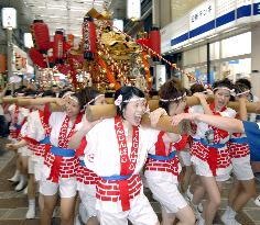 Women carry portable shrine in Tenjin Festival