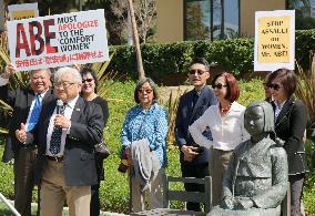 Congressman stands beside statue symbolizing "comfort women"
