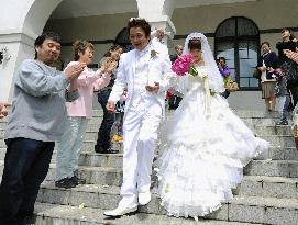 Friends celebrate tsunami survivors' wedding