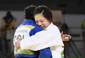 Olympic scenes: Gold, silver medalists embrace after judo final