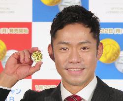 Figure skater Daisuke Takahashi with Olympic coin