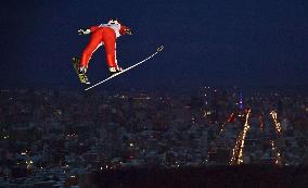 Japanese ski jumper Nakamura leaps toward Sapporo night view