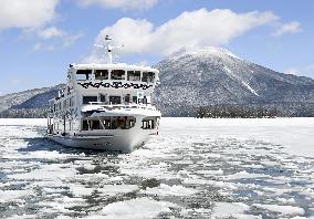 Sightseeing boat breaks ice on Lake Akan in Hokkaido